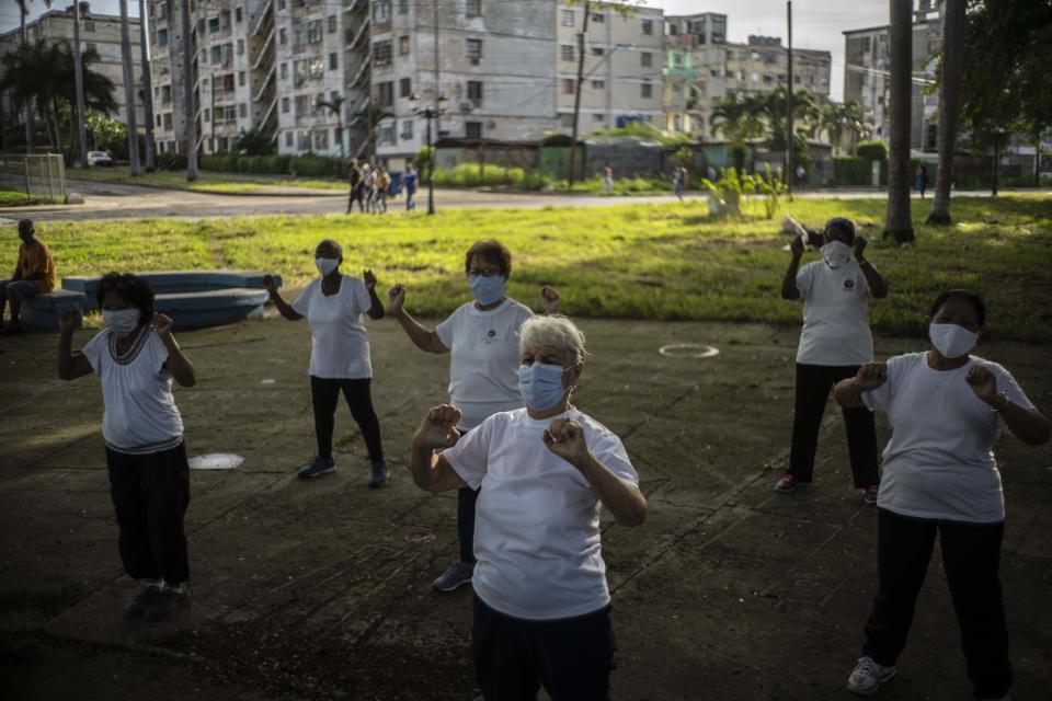 Con máscaras faciales en medio de la pandemia del nuevo coronavirus, la gente practica Tai Chi en un parque en La Habana, Cuba, el miércoles 28 de octubre de 2020. (AP Foto/Ramón Espinosa)