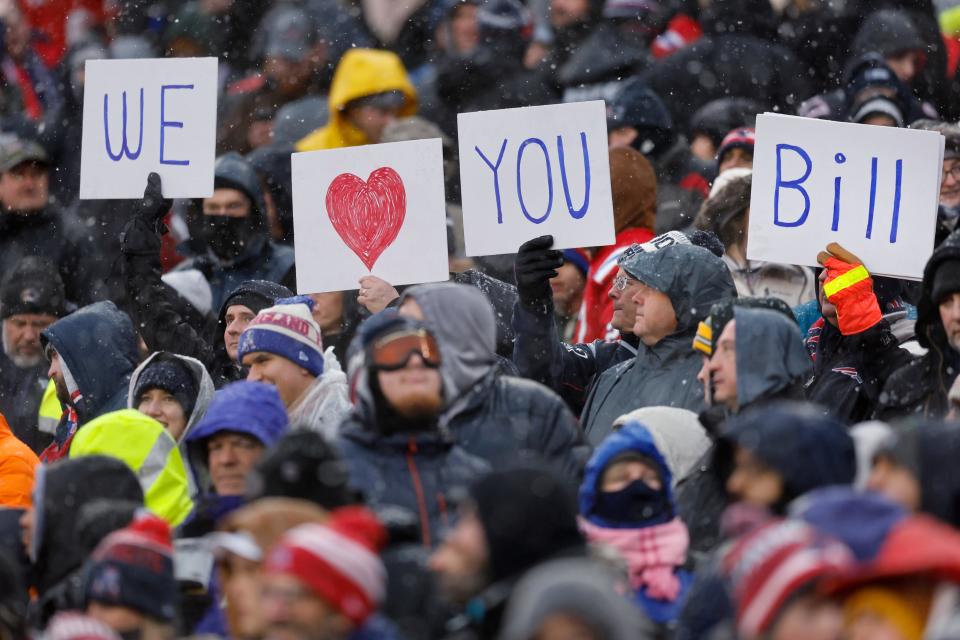 Fans show their support for Patriots head coach Bill Belichick during the first half Sunday against the New York Jets. The Pats lost, 17-3.