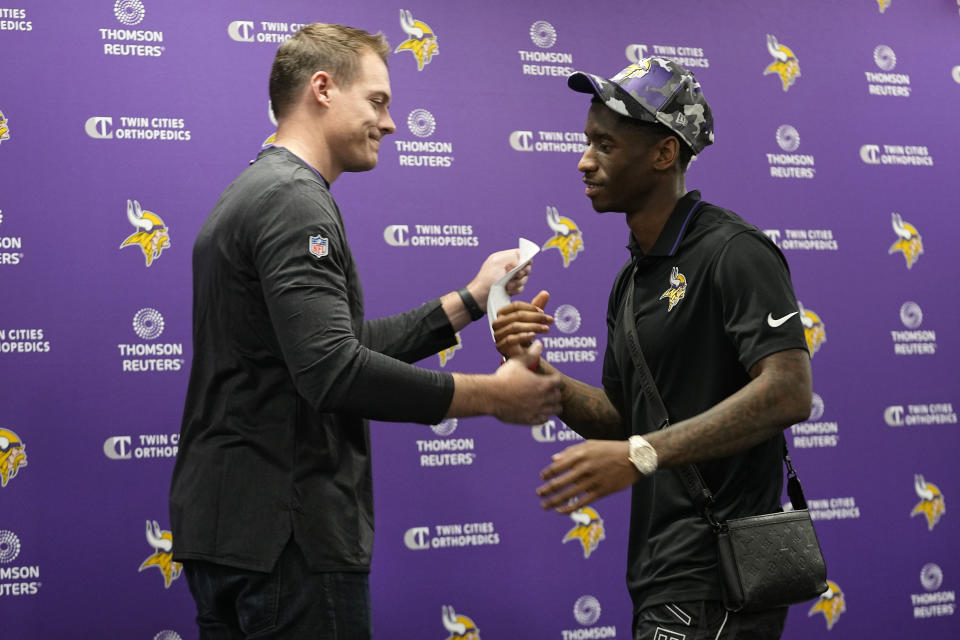 Minnesota Vikings head coach Kevin O'Connell, left, shakes hands with first-round draft pick Jordan Addison during an NFL football press conference in Eagan, Minn., Friday, April 28, 2023. (AP Photo/Abbie Parr)