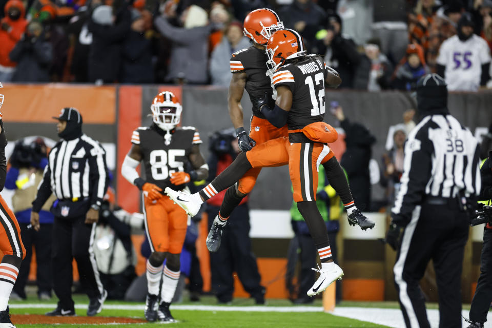 Cleveland Browns' Donovan Peoples-Jones, center left, celebrates his touchdown with Michael Woods II during the second half of an NFL football game against the Baltimore Ravens, Saturday, Dec. 17, 2022, in Cleveland. (AP Photo/Ron Schwane)