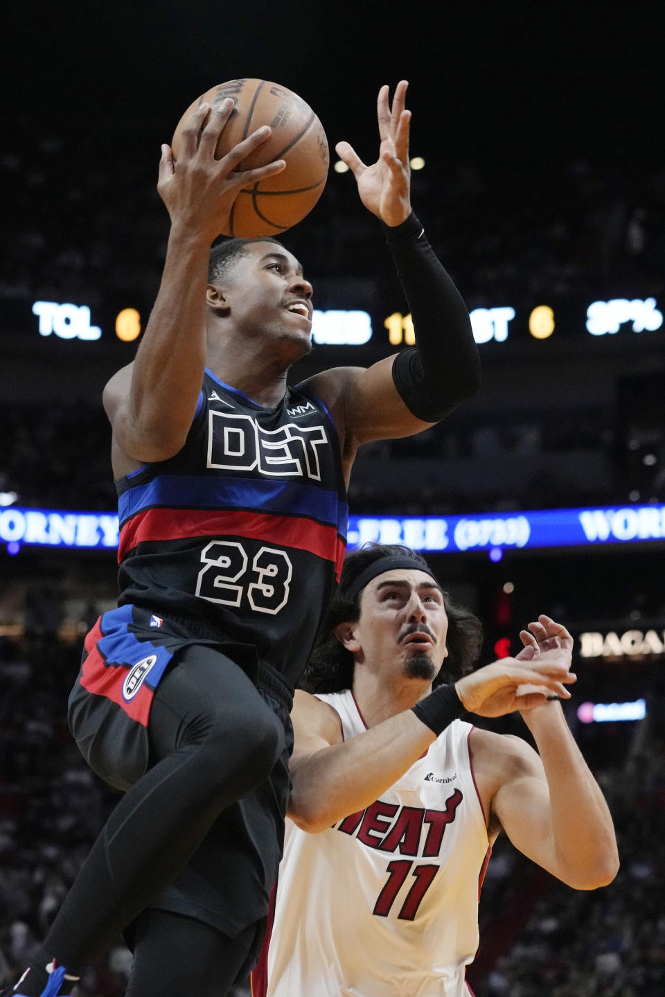 Detroit Pistons guard Jaden Ivey (23) derives to the basket over Miami Heat guard Jaime Jaquez Jr. (11) during the first half of an NBA basketball game, Wednesday, Oct. 25, 2023, in Miami. (AP Photo/Marta Lavandier)