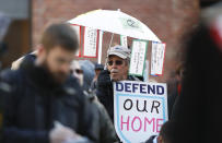 Jeff Baysinger of Lakewood, Colo., holds an umbrella at a rally of advocates to voice opposition to efforts by the Trump administration to weaken the National Environmental Policy Act, which is the country's basic charter for protection of the outdoors on Tuesday, Feb. 11, 2020, in Denver. (AP Photo/David Zalubowski)