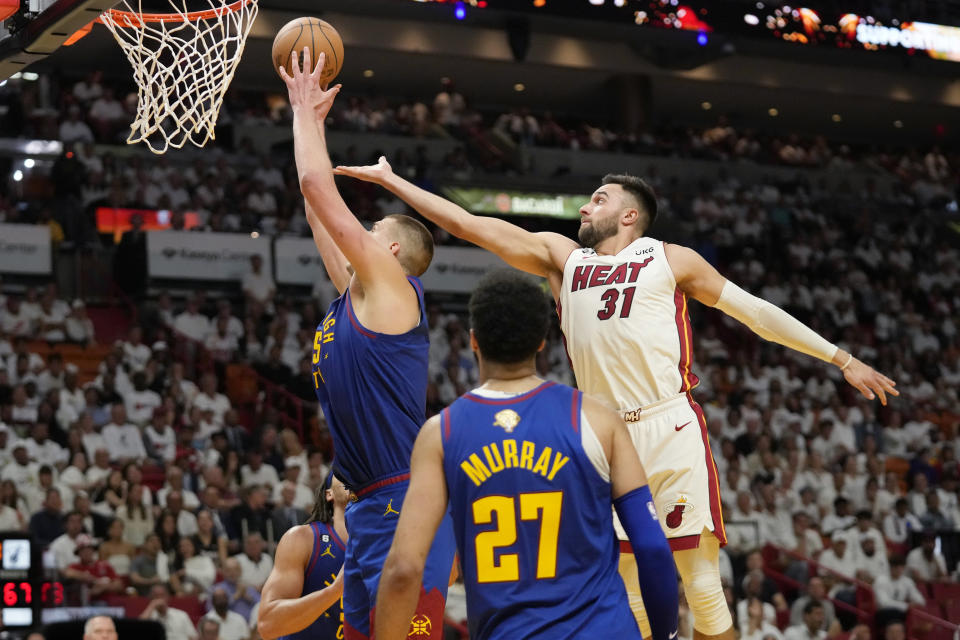 Denver Nuggets center Nikola Jokic (15) drives to the basket as Miami Heat guard Max Strus (31) attempts to defend during the first half of Game 3 of the NBA Finals basketball game, Wednesday, June 7, 2023, in Miami. (AP Photo/Wilfredo Lee)