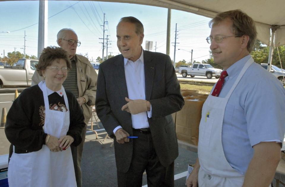 Former Sen. Bob Dole, center, talks to Callie Daniels and Steve Shattuck, chairman of the Shriner Club, as Dole visits a Shriner's Fish Fry in a Skibo Road parking lot in October of 2008. Dole, who was the Republican nominee for president in 1996, died Sunday, Dec. 5, 2021.