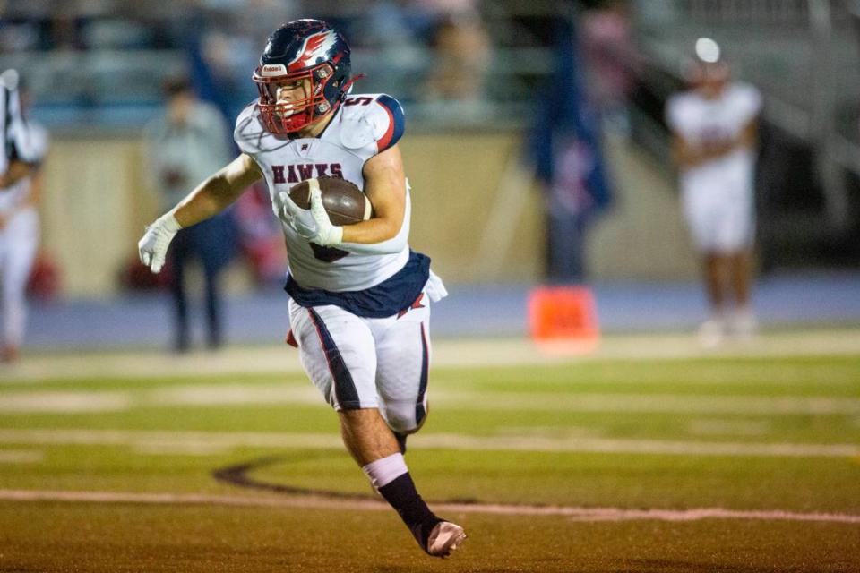 Hancock’s Zach Gullung carries the ball down the field during a game against St. Martin at Joe Barlow Stadium in St. Martin on Friday, Sept. 30, 2022.