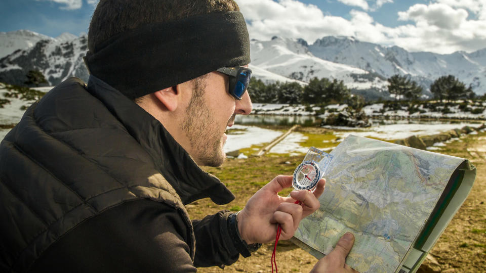 how to take a bearing: hiker taking a bearing