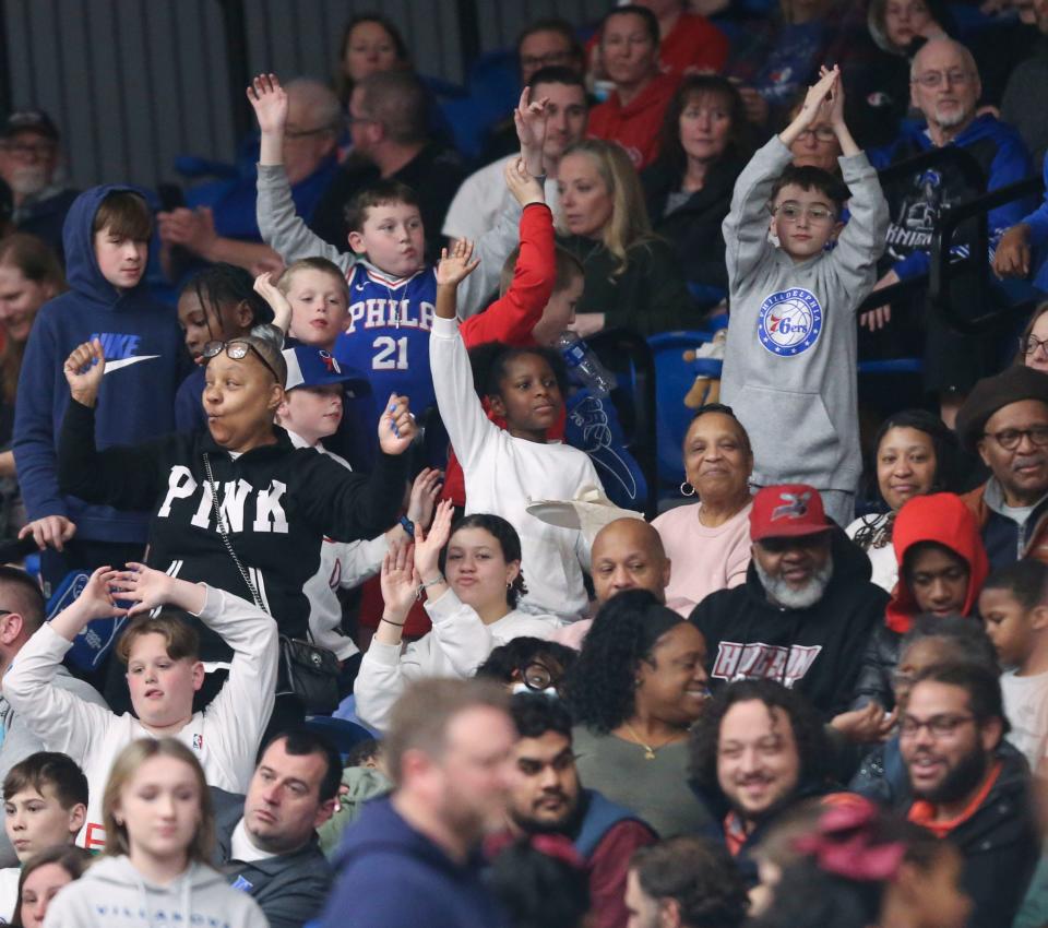 Fans look for giveaway t-shirts in a break during the Blue Coats' loss to Fort Wayne Friday, March 24, 2023 at the Chase Fieldhouse.