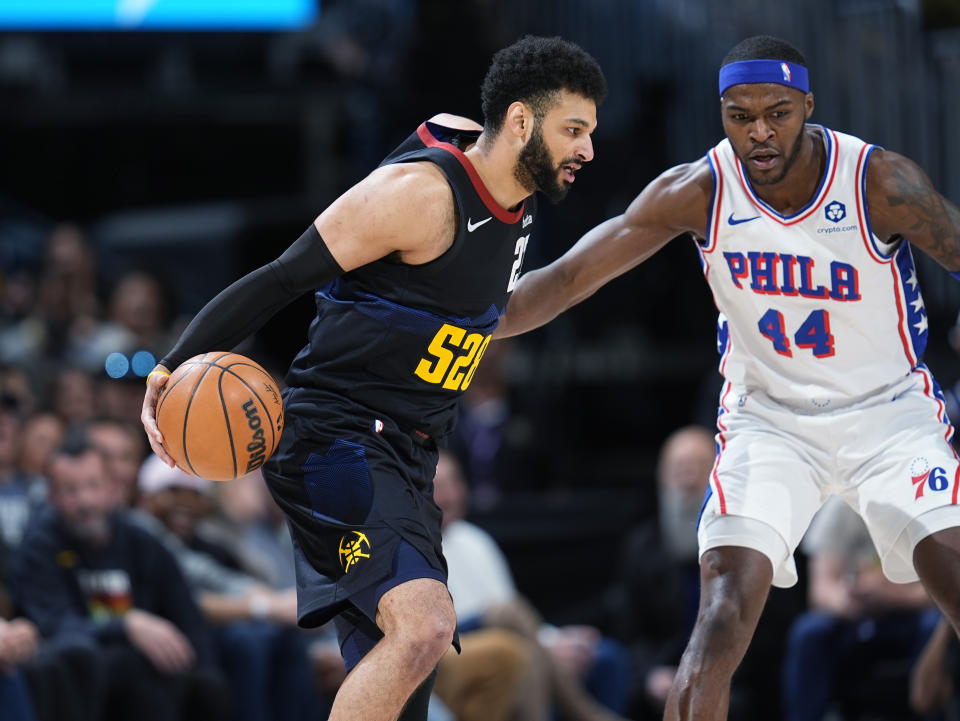 Denver Nuggets guard Jamal Murray, left, drives past Philadelphia 76ers forward Paul Reed in the first half of an NBA basketball game, Saturday, Jan. 27, 2024, in Denver. (AP Photo/David Zalubowski)