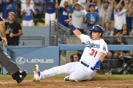 Jul 13, 2018; Los Angeles, CA, USA; Los Angeles Dodgers left fielder Joc Pederson (31) slides home to score against the Los Angeles Angels on a double by first baseman Max Muncy (not pictured) in the seventh inning at Dodger Stadium. Mandatory Credit: Richard Mackson-USA TODAY Sports