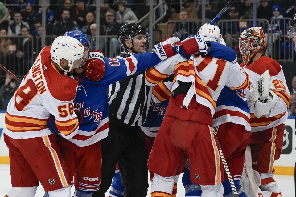 Players fight during the second period an NHL hockey game between the New York Rangers and the Calgary Flames on Monday, Feb. 12, 2024, in New York. (AP Photo/Bryan Woolston)