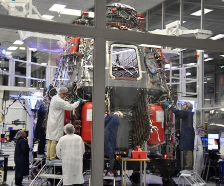 SpaceX technicians work on the next Crew Dragon Demo-2 craft as NASA Administrator Jim Bridenstine tours SpaceX headquarters with NASA astronauts Bob Behnken and Doug Hurley in Hawthorne