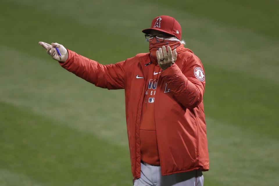 Los Angeles Angels manager Joe Maddon gestures toward umpires during the eighth inning of a baseball game between the Oakland Athletics and the Angels in Oakland, Calif., Friday, July 24, 2020. (AP Photo/Jeff Chiu)