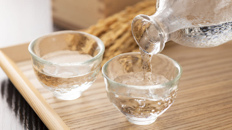 Pouring sake in a clear cup