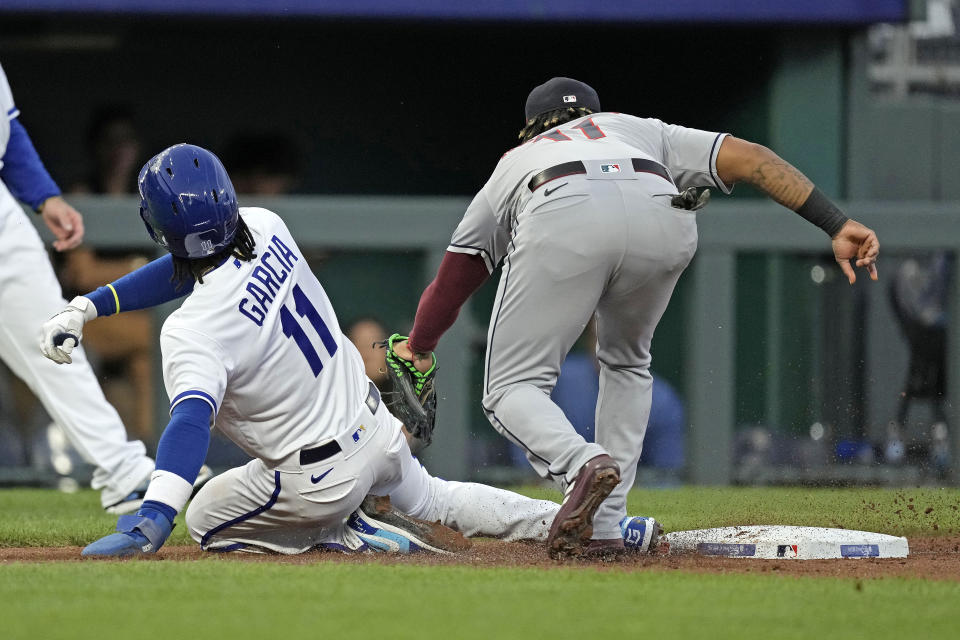 Kansas City Royals' Maikel Garcia (11) is tagged out by Cleveland Guardians third baseman Jose Ramirez after getting caught off base during the first inning of a baseball game Tuesday, Sept. 19, 2023, in Kansas City, Mo. (AP Photo/Charlie Riedel)