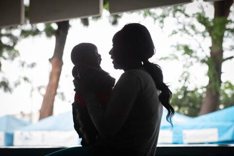 A young woman with a baby - Credit: Simon Townsley/The Telegraph