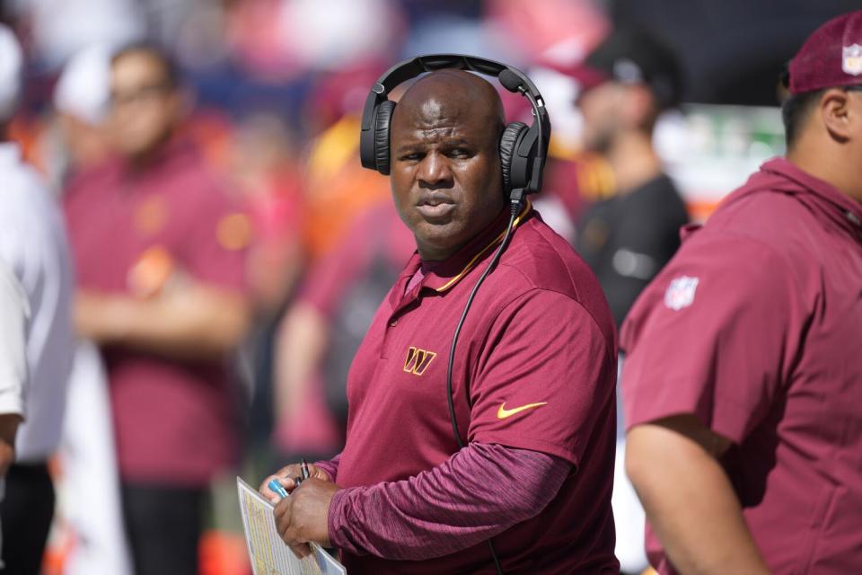 Eric Bieniemy stands on the sideline during a game between the Commanders and Denver Broncos in September.