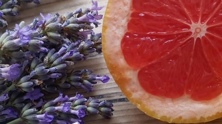 Close-up of a slice of grapefruit with fresh lavender flowers