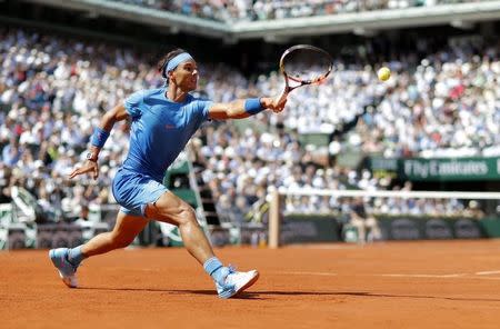 Rafael Nadal of Spain returns the ball to Novak Djokovic of Serbia during their men's quarter-final match during the French Open tennis tournament at the Roland Garros stadium in Paris, France, June 3, 2015. REUTERS/Vincent Kessler