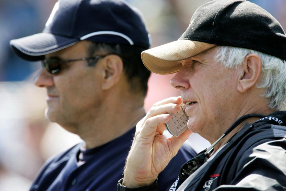 New York Yankees scout Gene Michael, right, talks on his cell phone while watching batting practice with manager Joe Torre, at Legends Field in Tampa, Fla., on Feb. 21, 2007.