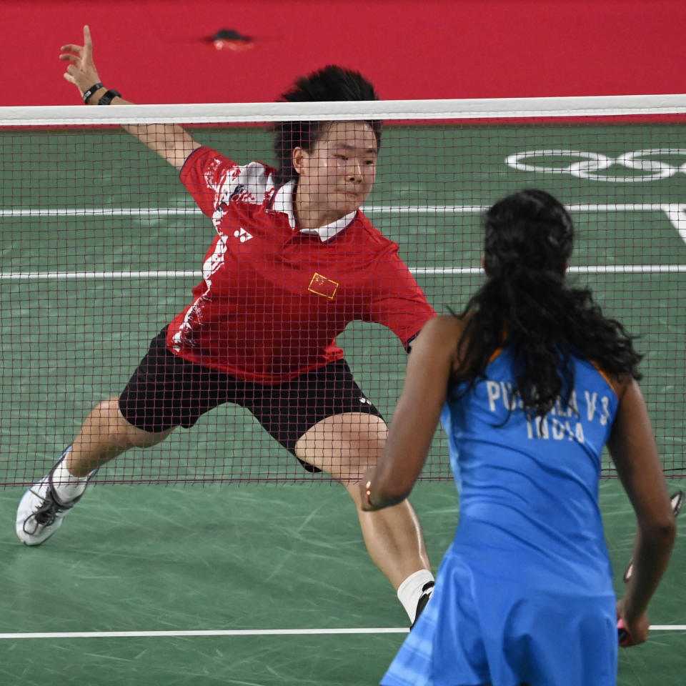 China's He Bingjiao (top) hits a shot to India's P. V. Sindhu in their women's singles badminton bronze medal match during the Tokyo 2020 Olympic Games at the Musashino Forest Sports Plaza in Tokyo on August 1, 2021. (Photo by Alexander NEMENOV / AFP) (Photo by ALEXANDER NEMENOV/AFP via Getty Images)