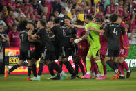 Houston Dynamo's Ivan Franco, left, is held back by teammates during an altercation between members of the Dynamo and St. Louis City during the first half of an MLS soccer match Saturday, June 3, 2023, in St. Louis. (AP Photo/Jeff Roberson)