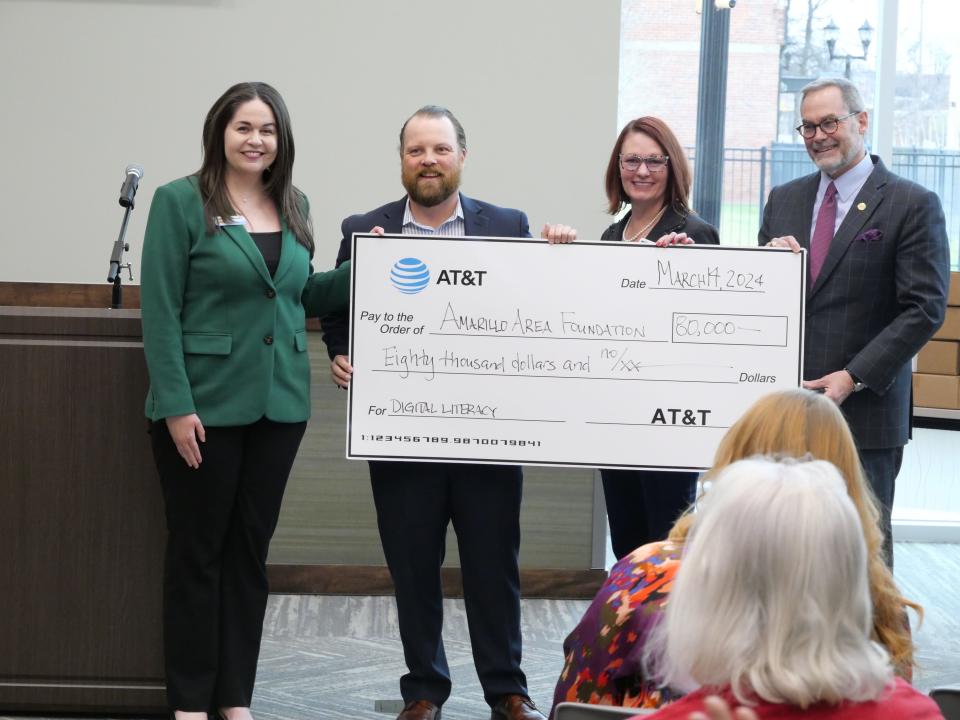 Amarillo Area Foundation (AAF) Senior Vice President, Keralee Clay accepts an $80,000 donation from AT&T for the foundation's digital literacy program during Thursday morning's announcement held in the AAF conference room.