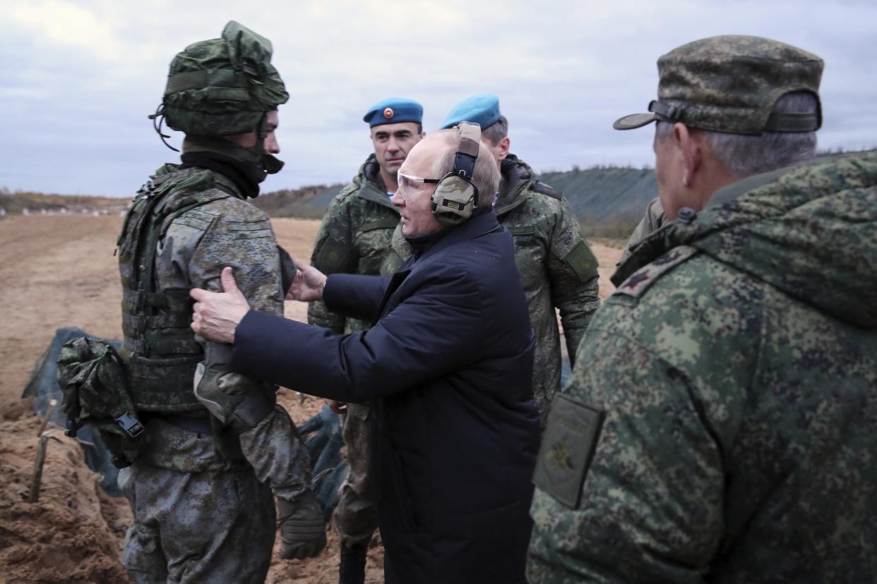 FILE - Russian President Vladimir Putin, center, speaks to a soldier as he visits a military training center of the Western Military District for mobilized reservists in the Ryazan region of Russia, on Oct. 20, 2022. (Mikhail Klimentyev/Sputnik/Kemlin Pool Photo via AP, File)