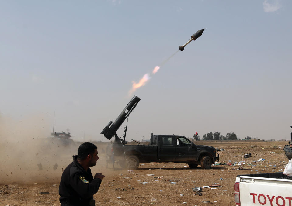 In this Monday, March 30, 2015 file photo Iraqi security forces launch a rocket against Islamic State extremist positions during clashes in Tikrit, 80 miles north of Baghdad, Iraq. (AP Photo/Khalid Mohammed, File)
