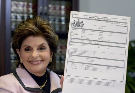 Attorney Gloria Allred holds a copy of a criminal complaint by Montgomery County, Pennsylvania, during a news conference in Los Angeles, California to comment on the aggravated indecent assault charges filed against comedian Bill Cosby by the Montgomery County, Pennsylvania District Attorney December 30, 2015. REUTERS/Kevork Djansezian