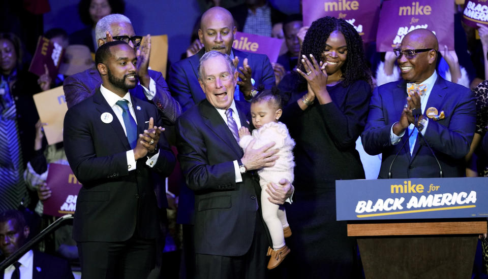 Democratic presidential candidate and former New York City Mayor Michael Bloomberg, center, is joined on stage by supporters during his campaign launch of "Mike for Black America," at the Buffalo Soldiers National Museum, Thursday, Feb. 13, 2020, in Houston. (AP Photo/David J. Phillip)