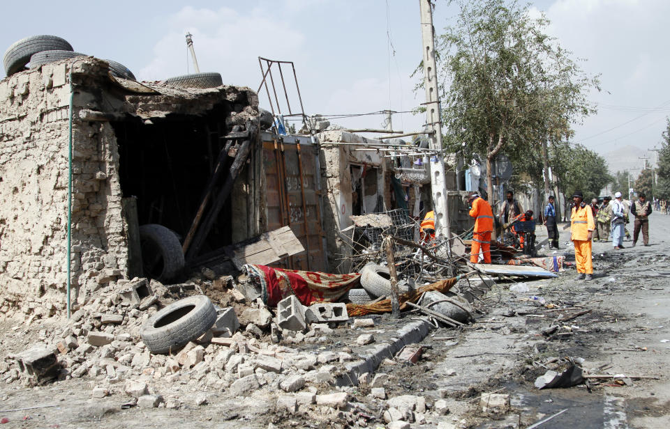 Afghan municipality workers clear debris after an explosion in Kabul, Afghanistan, Wednesday, Sept. 9, 2020. Spokesman for Afghanistan's Interior Ministry said the bombing that targeted the convoy of the country's first vice president on Wednesday morning killed several people and wounded more than a dozen others, including several of the vice president's bodyguards. (AP Photo/Rahmat Gul)