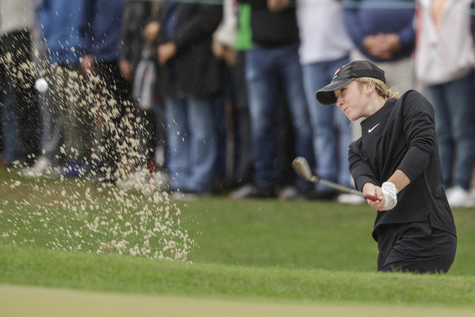 Izzi Stricker hits sand shot during the final round of the PNC Championship golf tournament Sunday, Dec. 17, 2023, in Orlando, Fla. (AP Photo/Kevin Kolczynski)