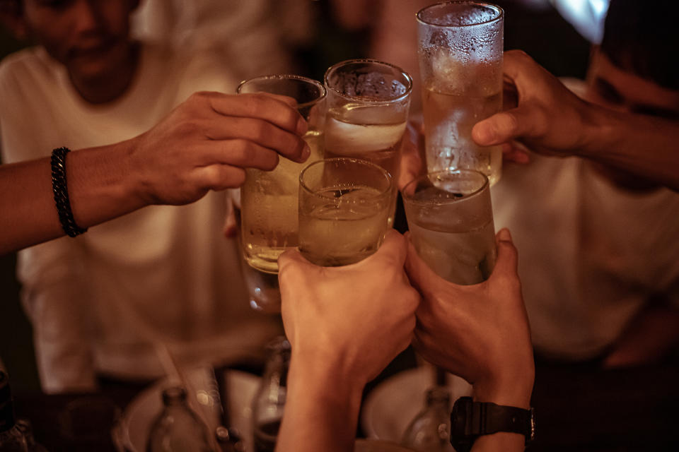 people cheering their beer