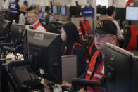 Pacific Gas & Electric employees work in the PG&E Emergency Operations Center in San Francisco, Thursday, Oct. 10, 2019. More than 1.5 million people in Northern California were in the dark Thursday, most for a second day, after the state's biggest utility shut off electricity to many areas to prevent its equipment from sparking wildfires as strong winds sweep through. (AP Photo/Jeff Chiu)