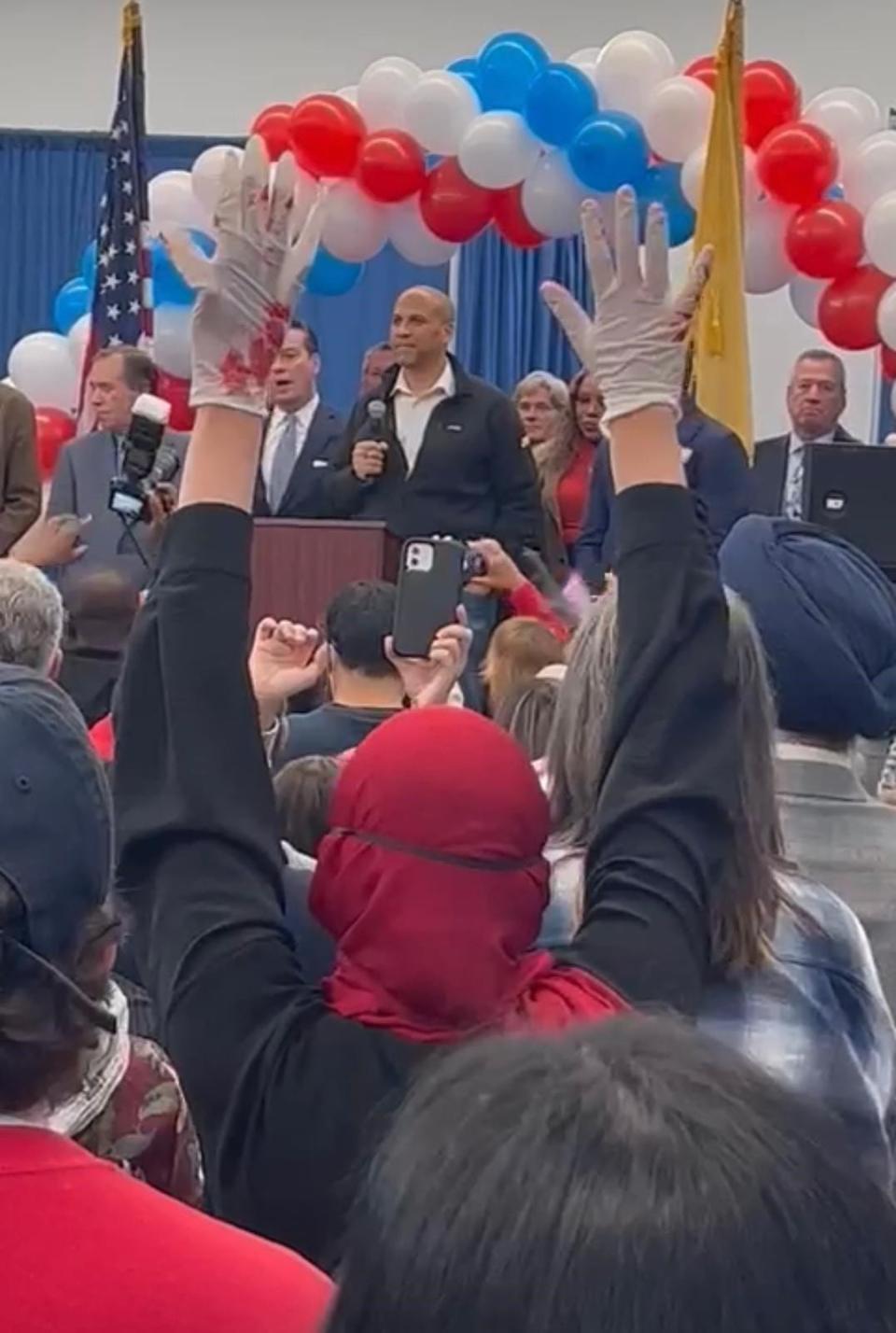 Sen. Cory Booker was met with protest during an election event on Sunday, Nov. 5, in South Brunswick. Protesters shouted "Cease-fire now" and held up red-dyed hands to symbolize more than 10,000 Gazans reported killed.