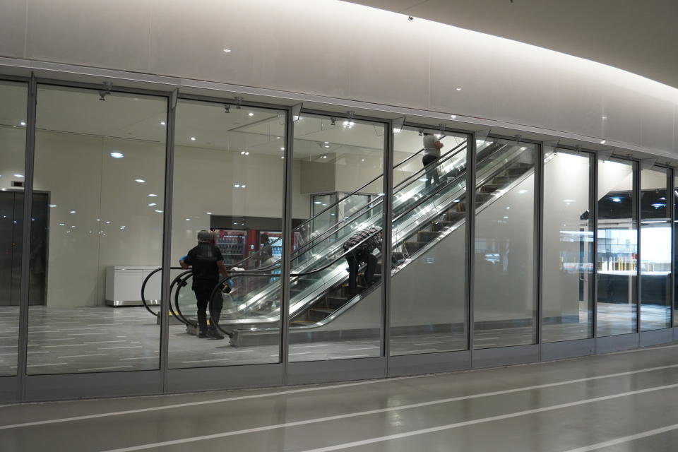 Crews were polishing the escalators moments before the doors opened to the public on Saturday morning. 