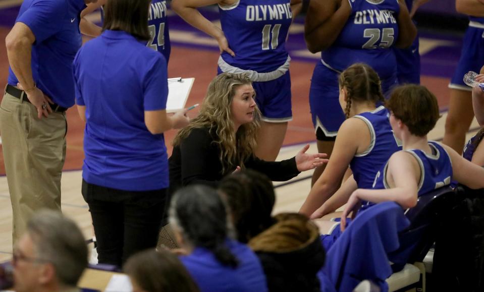 Olympic Trojans head coach Kelsey Callaghan talks to her team during a timeout against the North Kitsap Vikings in Poulsbo on Tuesday, Dec. 6, 2022.