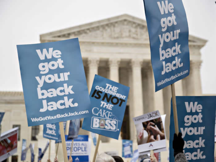 Demonstrators hold signs in support of Masterpiece Cakeshop owner Jack Phillips outside the U.S. Supreme Court during arguments in the Masterpiece Cakeshop v. Colorado Civil Rights Commission case in Washington, D.C., U.S., on Tuesday, Dec. 5, 2017. A pivotal justice sent mixed messages as the Supreme Court heard arguments in the case of a Colorado baker who refuses to make cakes for same-sex weddings. The state has ordered him to either make cakes for gay weddings or stop making wedding cakes at all. Photographer: Andrew Harrer/Bloomberg via Getty Images