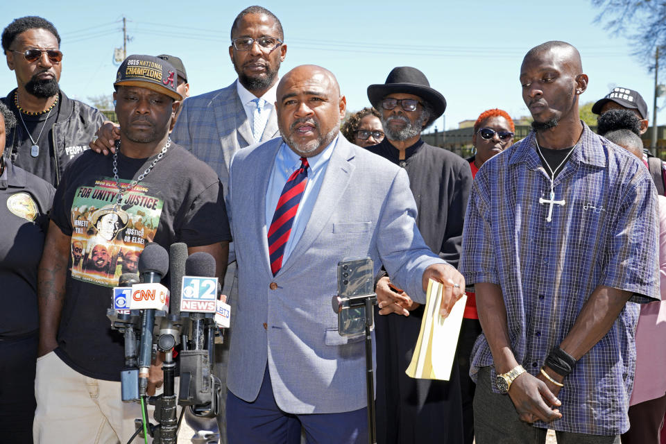 Michael Corey Jenkins, right, and Eddie Terrell Parker, left, stand with their local attorney Trent Walker, as he calls on a federal judge at a news conference Monday, March 18, 2024, in Jackson, Miss., to impose the harshest possible penalties against six former Mississippi Rankin County law enforcement officers who committed numerous acts of racially motivated, violent torture on them in 2023. The six former law officers pleaded guilty to a number of charges for torturing them and sentencing for them starts on Tuesday. (AP Photo/Rogelio V. Solis)