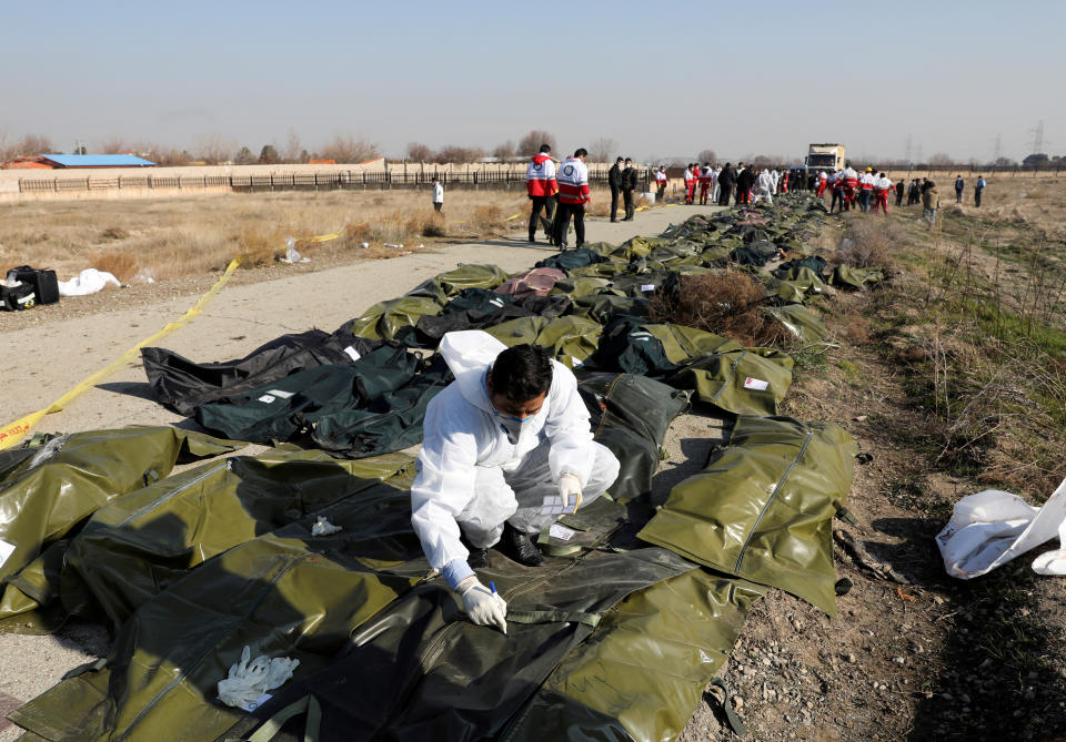 Passengers' bodies in plastic bags are pictured at the site where the Ukraine International Airlines plane crashed after take-off from Iran's Imam Khomeini airport, on the outskirts of Tehran, Iran January 8, 2020. Nazanin Tabatabaee/WANA (West Asia News Agency) via REUTERS