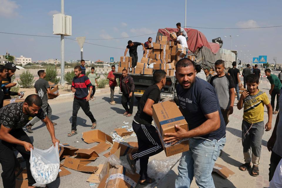 People unpack boxes of humanitarian aid from a truck that entered the southern Gaza Strip from Egypt via the Rafah border crossing on Nov. 2, 2023.