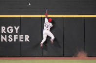 RETRANSMISSION TO CORRECTION NAME TO MATT CHAPMAN - Texas Rangers center fielder Adolis Garcia leaps but can't get the ball at the fence on a home run by Oakland Athletics Matt Chapman in the first inning of a baseball game Tuesday, June 22, 2021, in Arlington, Texas. (AP Photo/Louis DeLuca)