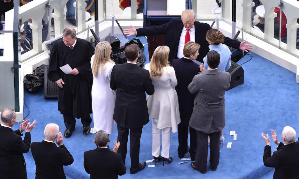 <p>Trump extends his arms to his five children and his wife Melania.</p>