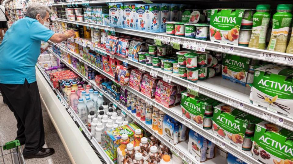 elderly man in yogurt aisle, shopping at designated senior time during pandemic