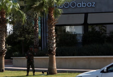 A Kurdish security member stands guard near a restaurant where Turkish diplomats and Turkish consulate employee were killed in Erbil