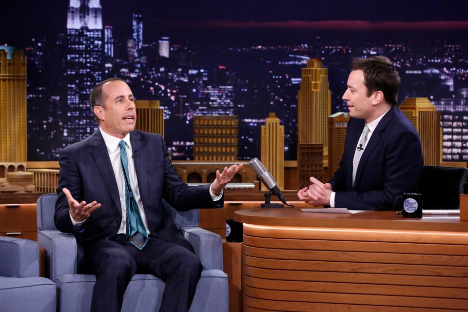 Jerry Seinfeld sitting on The Tonight Show stage next to host Jimmy Fallon