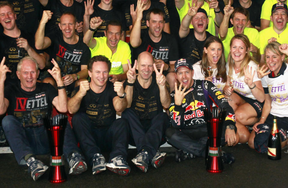 Red Bull Formula One driver Sebastian Vettel of Germany (front, R) celebrates with Red Bull team members including team principal Christian Horner (front, 2nd L) and technial chief Adrian Newey (front, 3rd L) after the Indian F1 Grand Prix at the Buddh International Circuit in Greater Noida, on the outskirts of New Delhi, October 27, 2013. Vettel roared into the record books as Formula One&#39;s youngest four-times world champion after winning the Indian Grand Prix for the third year in a row on Sunday. REUTERS/Anindito Mukherjee (INDIA  - Tags: SPORT MOTORSPORT F1)  
