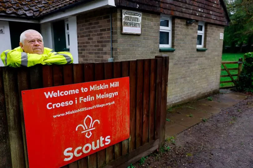 Graham, wearing a high-vis jacket, looks miserable as he leans on a fence at Miskin Mill