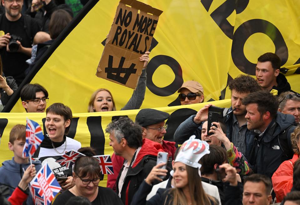 Anti-royal protestors hold up placards saying 'Not My King' as they demonstrate behind well-wishers in Trafalgar Square close to where Britain's King Charles III and Britain's Camilla, Queen Consort will be crowned at Westminster Abbey in central London on May 6, 2023. - The set-piece coronation is the first in Britain in 70 years, and only the second in history to be televised. Charles will be the 40th reigning monarch to be crowned at the central London church since King William I in 1066. Republican opponents who want an elected head of state plan to protest on the day with signs declaring 