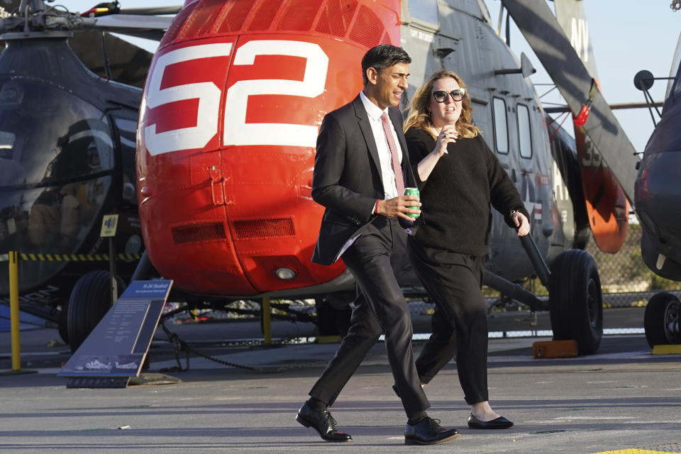 British Prime Minister Rishi Sunak, center left, walks on the deck of the USS Midway Aircraft Carrier in San Diego, Sunday, March 12, 2023, as he arrives in the States for meetings with U.S. President Joe Biden and Australia Prime Minister Anthony Albanese in AUKUS, a trilateral security pact among the three countries. (Stefan Rousseau/Pool Photo via AP)